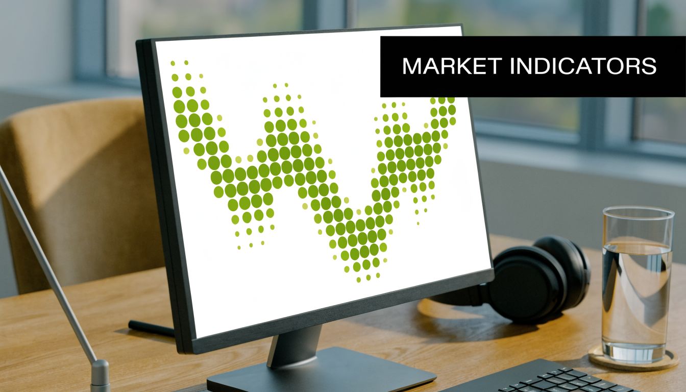 A modern office workspace featuring a computer monitor displaying a green dotted market analysis graph.