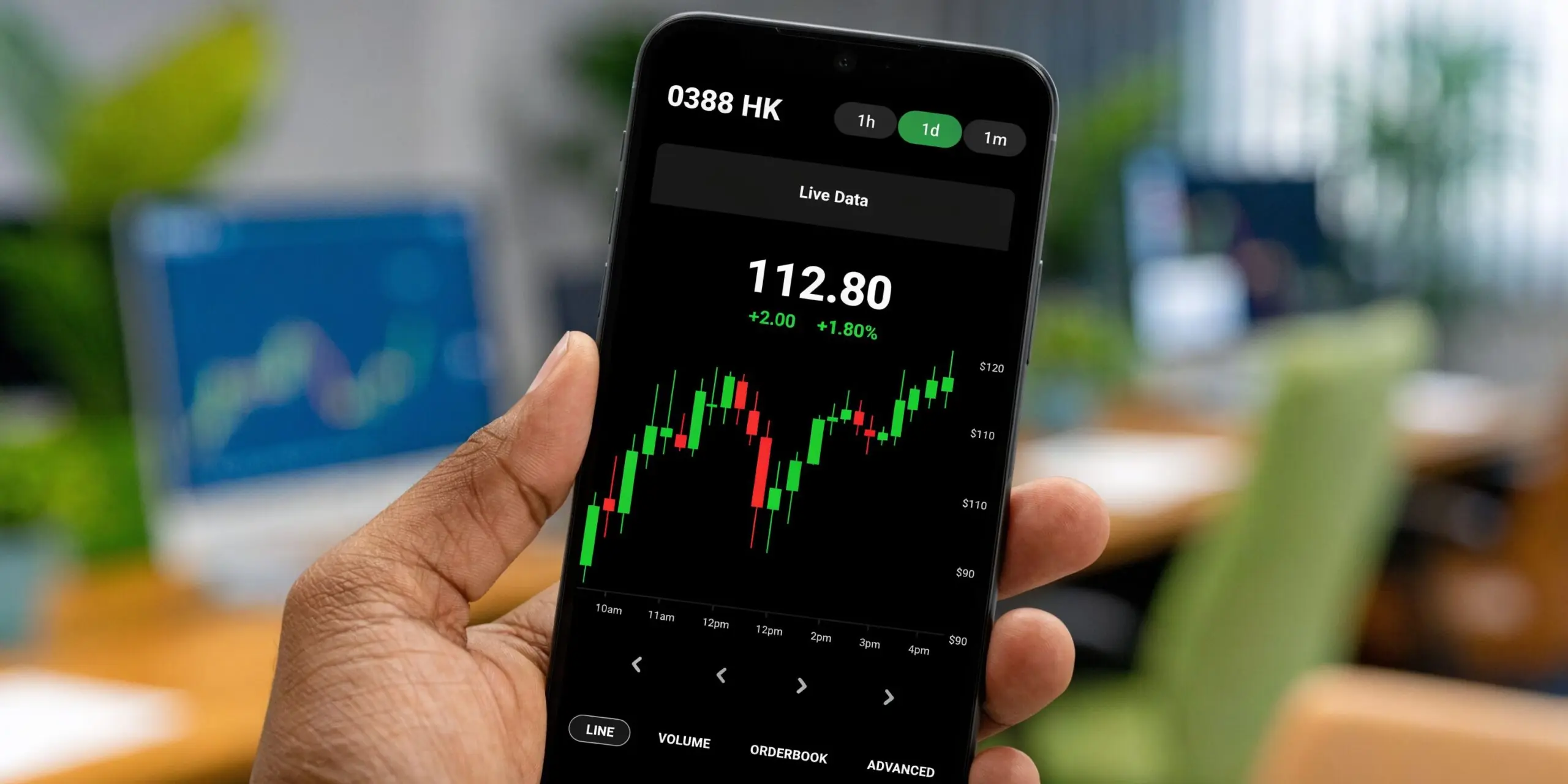 A hand holding a smartphone displaying the live stock market trading chart for 0388 HK.
